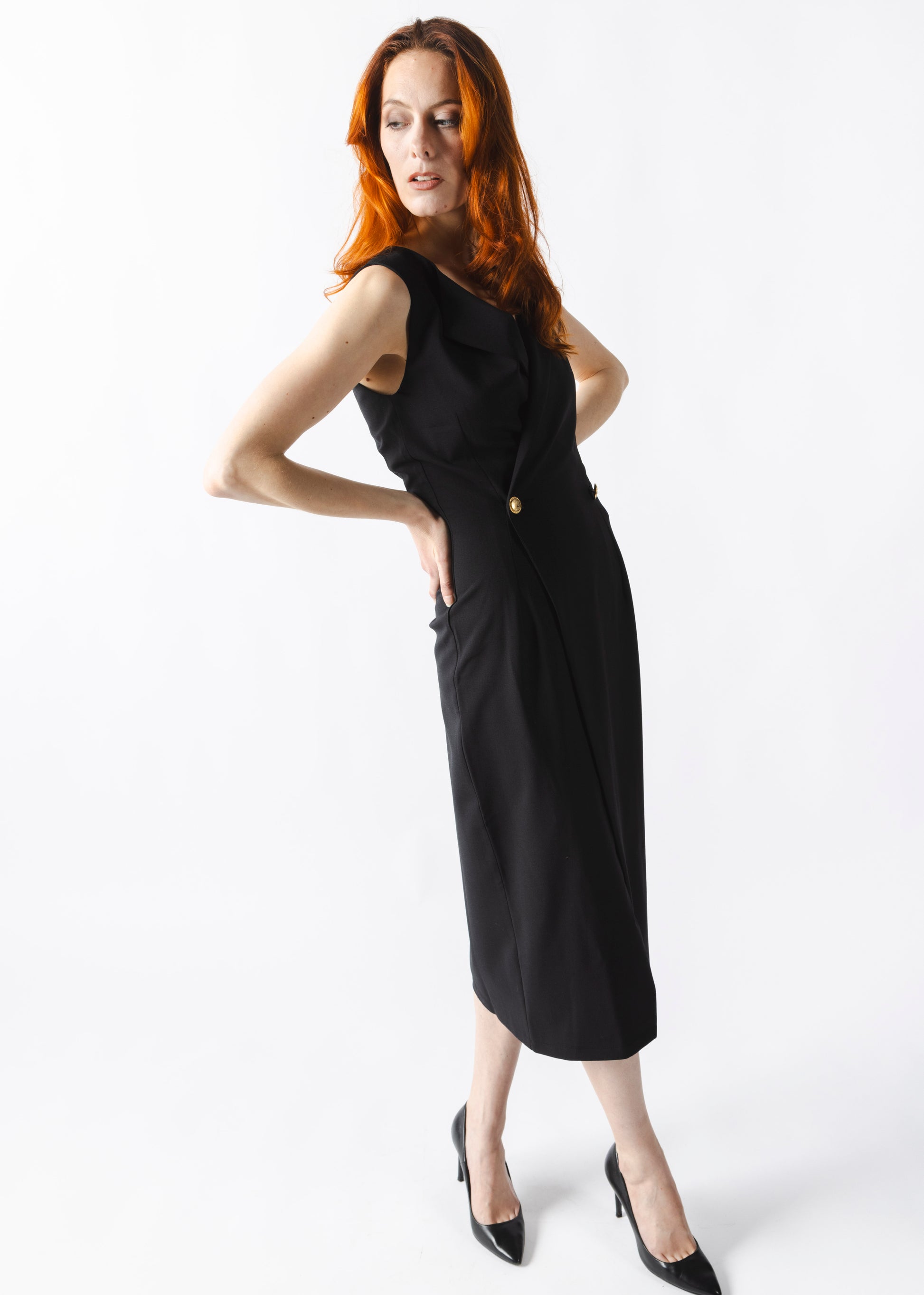 Robe tailleur noire élégante – Silhouette sculpturale avec boutons dorés, coupe ajustée et fente subtile. Luxe et modernité signés ALLAURA.